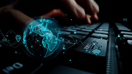 Explore the world of digital connectivity with a close-up on a computer keyboard, featuring global map visualizations that highlight modern communication technology.の写真素材