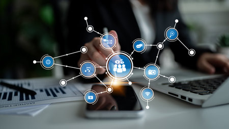 A business professional engages with a smartphone, showcasing a network of digital icons...