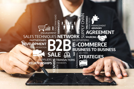A businessman works on a digital tablet to enhance B2B strategies, focusing on e-commerce,...