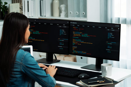 Young Asian IT developer creating and typing online information on a PC with a coding program,...