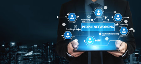 A business professional showcases digital networking concepts on a tablet, illuminated by city...