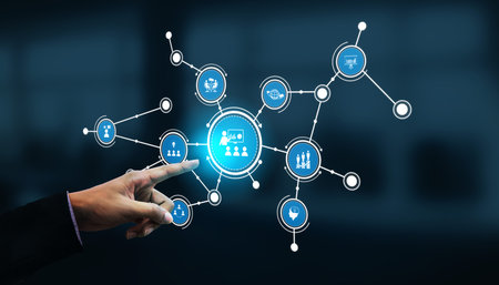 A businessman interacts with a digital network interface showcasing interconnected data and...