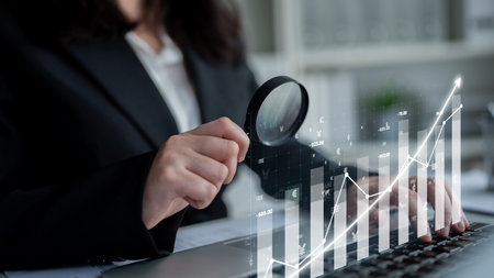 A professional examines financial data trends with a magnifying glass, emphasizing detailed analysis...