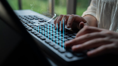A close-up shot of a person typing on a keyboard with financial growth graphics overlay, symbolizing...