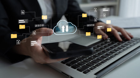 Business Person Using Smartphone and Laptop to Manage Cloud Data Storage with Digital Interface...