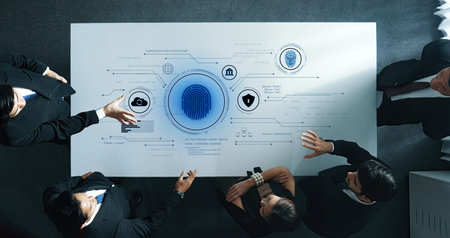 A business team engages around a modern table, exploring digital security solutions. The display...