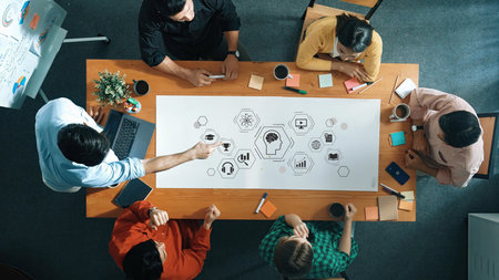Collaborative brainstorming session in modern office with diverse team analyzing ideas and...