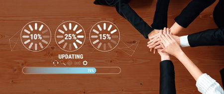 A diverse business team collaborates on project updates, showcasing hands joined together on a...