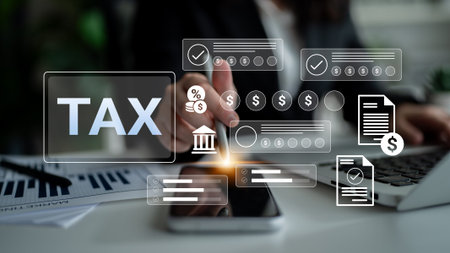 A business professional uses digital tools and graphs to prepare taxes, showcasing financial...