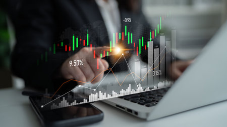A business professional analyzes financial data using a laptop in a modern office. Overlay graphics...