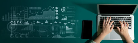 A professional workspace featuring a laptop and smartphone displaying business analytics and data...