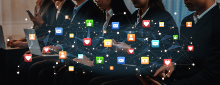 A diverse group of professionals uses digital devices in a corporate environment, symbolizing the...