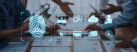 A dynamic business team engages in discussion around digital security themes, utilizing technology...