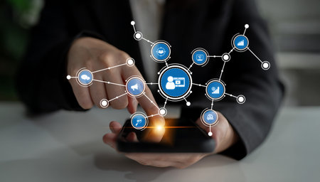 A businessman interacts with a smartphone, illustrated by digital connection icons, showcasing...