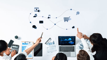 A diverse team collaborates around technology, utilizing data analytics and innovative strategies to...