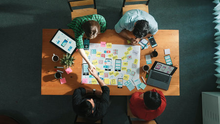 Professional developer team sharing idea of Ux Ui design by using mind map. Top down view of group of business people working together to brainstorm or plan mobile phone interface app. Convocation.の写真素材