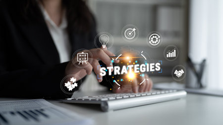 Business Professional Using Computer to Develop Strategic Plans with Various Digital Icons...