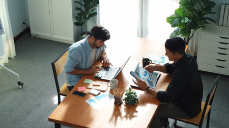 Skilled project manager walking at table while colleague brainstorm idea. Business team working...