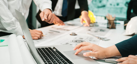 A collaborative team meeting taking place in a modern office where engineers and designers...