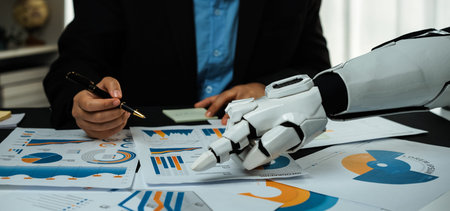 A futuristic business meeting showcasing a robot arm analyzing various charts and graphs. Emphasizing the blend of technology and data in the workplace.の写真素材