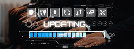A professional scene showcasing hands on laptops during a software update process. The digital...