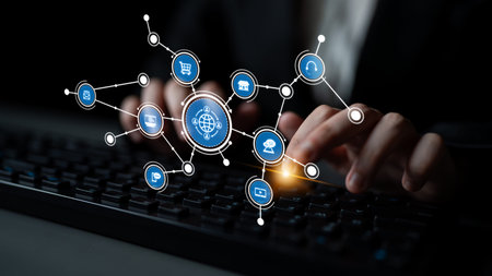 A close-up view of hands typing on a keyboard, with digital icons representing online commerce and...