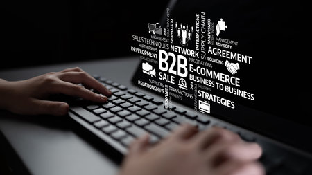 A close-up shot of hands typing on a keyboard, surrounded by business concepts and terms related to...