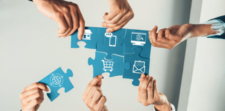 A dynamic scene illustrating teamwork, with diverse hands assembling puzzle pieces that depict...