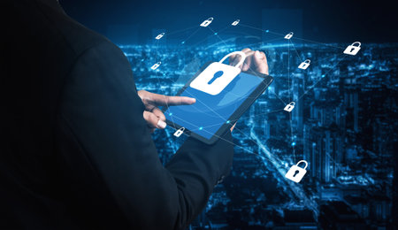 A businessman interacts with a digital tablet displaying security lock icons, set against a...