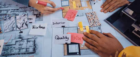 Professionals collaborate on architectural plans and design ideas, using color swatches and notes in...