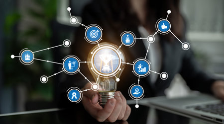 A light bulb symbolizes innovative ideas surrounded by digital connection icons, representing...