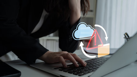 A business professional displays frustration while working on a laptop, alongside cloud data...