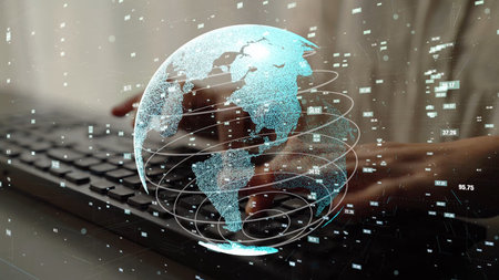 A close-up image of hands typing on a keyboard, accompanied by a glowing digital globe, symbolizing...