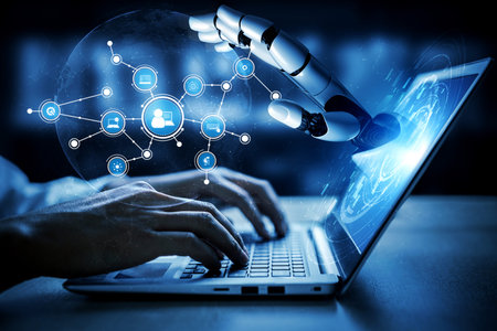 A close-up view of a robotic hand reaching toward a digital interface while a user types on a...