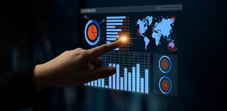 A close-up of a hand interacting with a digital dashboard displaying charts, graphs, and a world map...