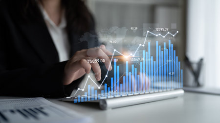 A business professional engages in data analysis, showcasing rising stock market trends on a digital...
