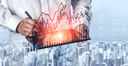 A business professional uses a digital tablet to analyze data trends, surrounded by an urban...