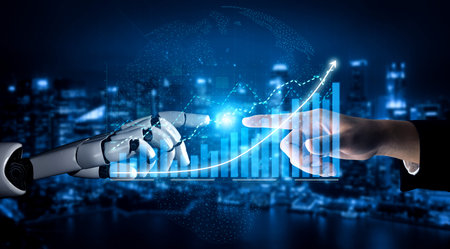 This image captures the symbolic interaction between a robotic hand and a human hand, representing the fusion of technology and human collaboration in a modern business landscape.の写真素材