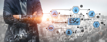 A businessman stands confidently in a suit against a modern city backdrop, highlighting key ESG concepts focused on environmental and social governance for corporate growth.の写真素材