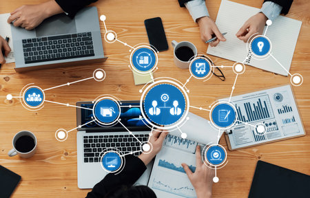 A top-down view of a collaborative business meeting showcasing technology and data analysis on a...