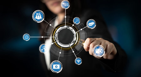 A business professional engages with a digital interface filled with various technology icons,...