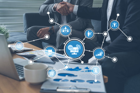 An engaging representation of business collaboration, showcasing a handshake alongside digital icons...