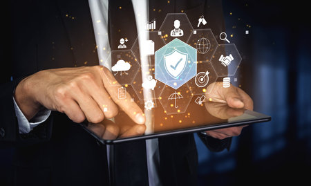 Businessman Using Tablet with Digital Security Icons, Business Analytics Graphics and Technology...