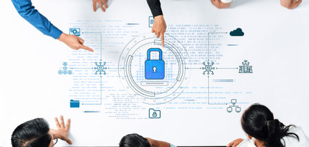 A diverse team collaborates around an office table, analyzing cybersecurity concepts while pointing...