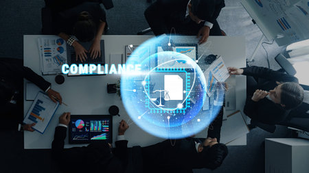A diverse group of professionals engages in a strategic business meeting focused on compliance,...