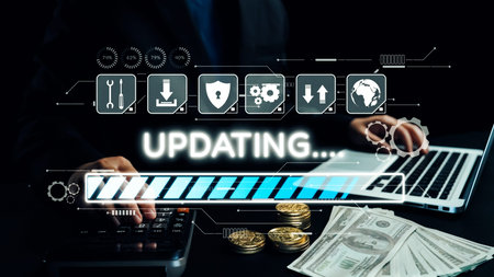A businessman updates financial data using a laptop while handling cash and coins. The dark...