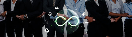 A diverse group of professionals stands together with crossed hands, symbolizing teamwork,...