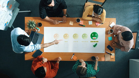 A diverse team engages in a productive meeting, evaluating feedback and ratings. The modern office...