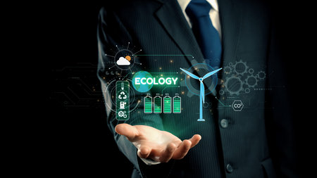 A businessman in a suit displays various digital ecology concepts, including wind turbines and...