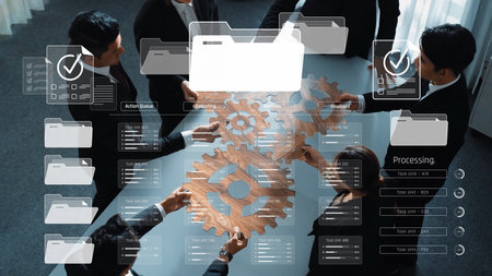 A diverse business team collaborates at a table with gears and a digital interface, illustrating...
